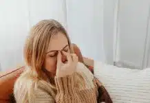 Woman Holding Her Nose Because of Sinus Pain