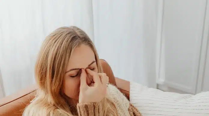 Woman Holding Her Nose Because of Sinus Pain